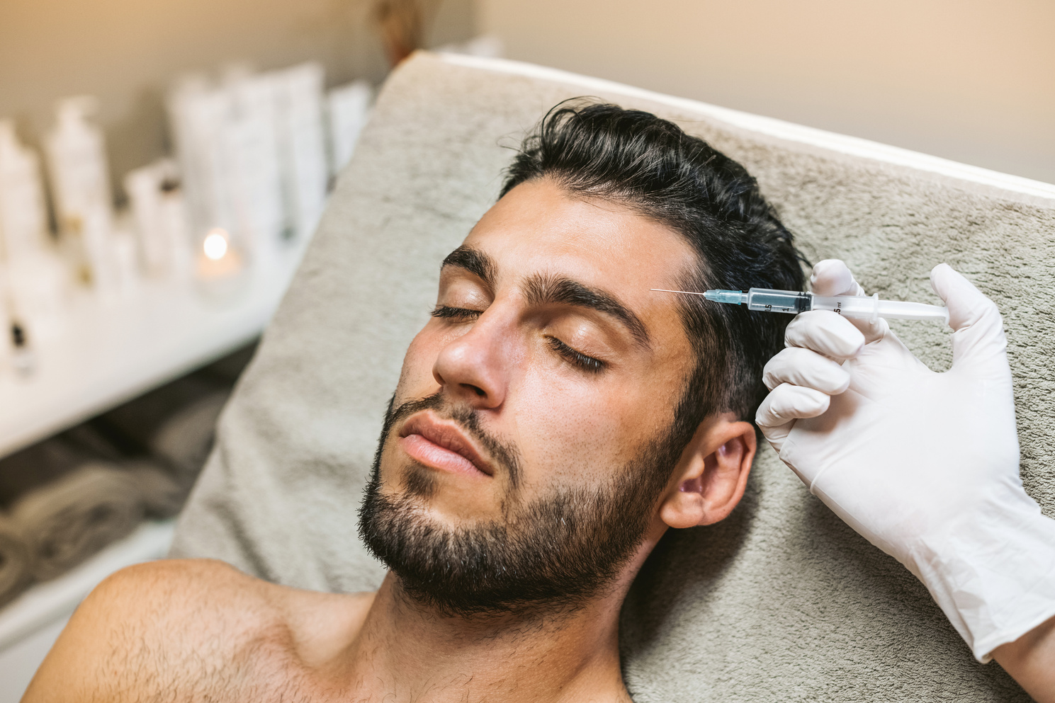 Calm man having botox rejuvenation procedure